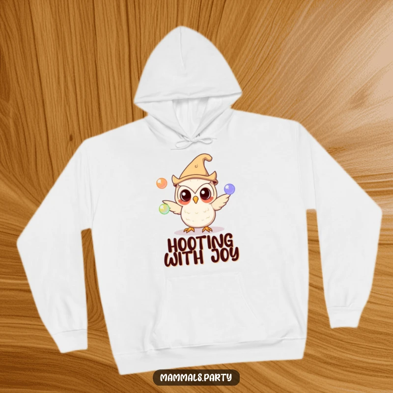 Funny owl character in a silly hat juggling glowing orbs on a cozy hoodie, perfect for warm, curious, and funny moments.