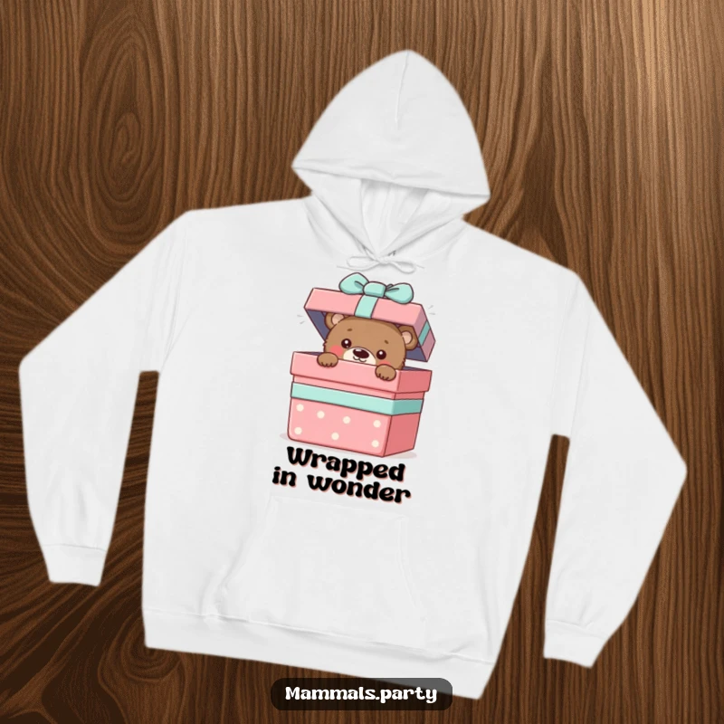 Funny hoodie showing a cute bear cub peeking from a giant gift box, embodying playful curiosity and surprise.