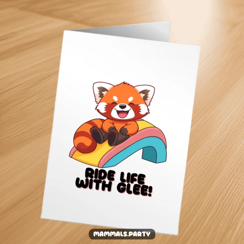 Funny Free Printable Birthday Card: Giggling red panda joyfully slides down a vibrant rainbow, spreading cheer and laughter.
