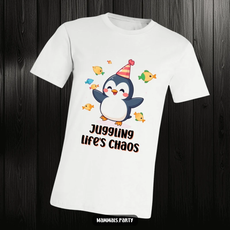 Funny t-shirt depicting a cheerful penguin wearing a party hat and juggling fish, embodying pure celebration and joy.
