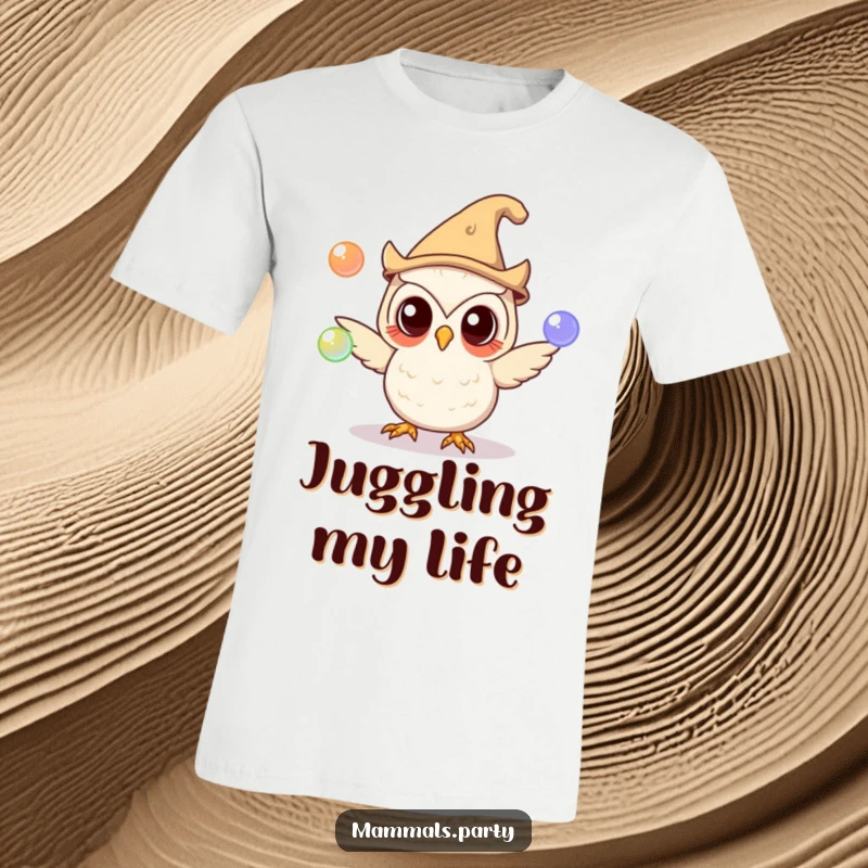 Funny owl wearing a silly hat, skillfully juggling glowing orbs, depicted on a t-shirt, showcasing magical and humorous talent.